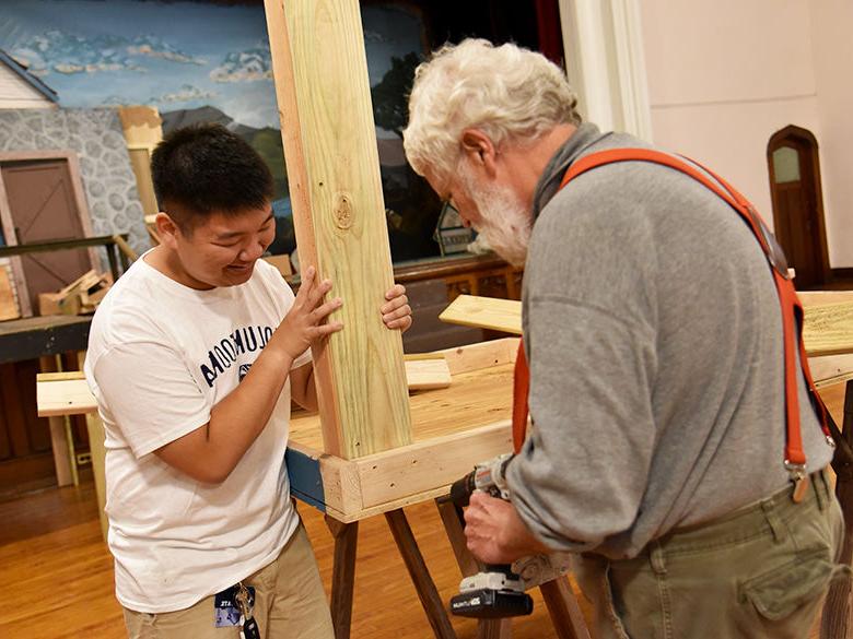 A student helps a member of the community during the annual Voluntoona community service event